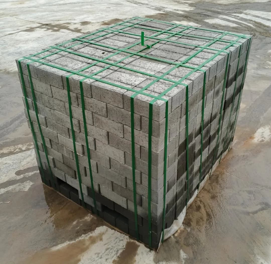 Crane lifting a strapped pallet onto a delivery truck