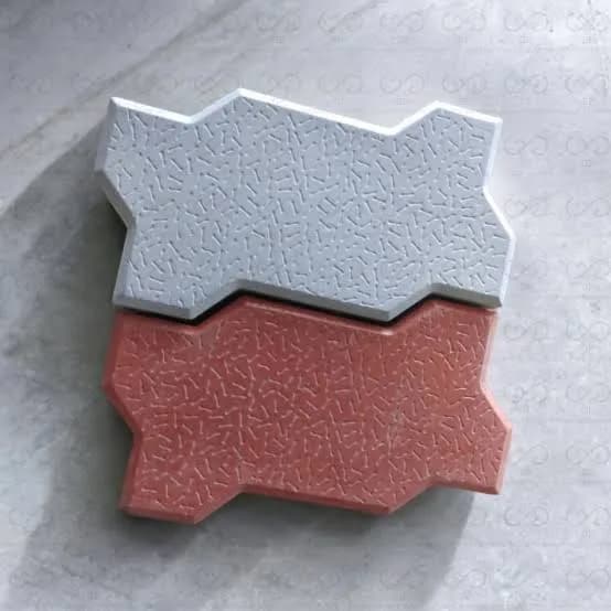 Two ZigZag paver units in grey and red showing the interlocking profile